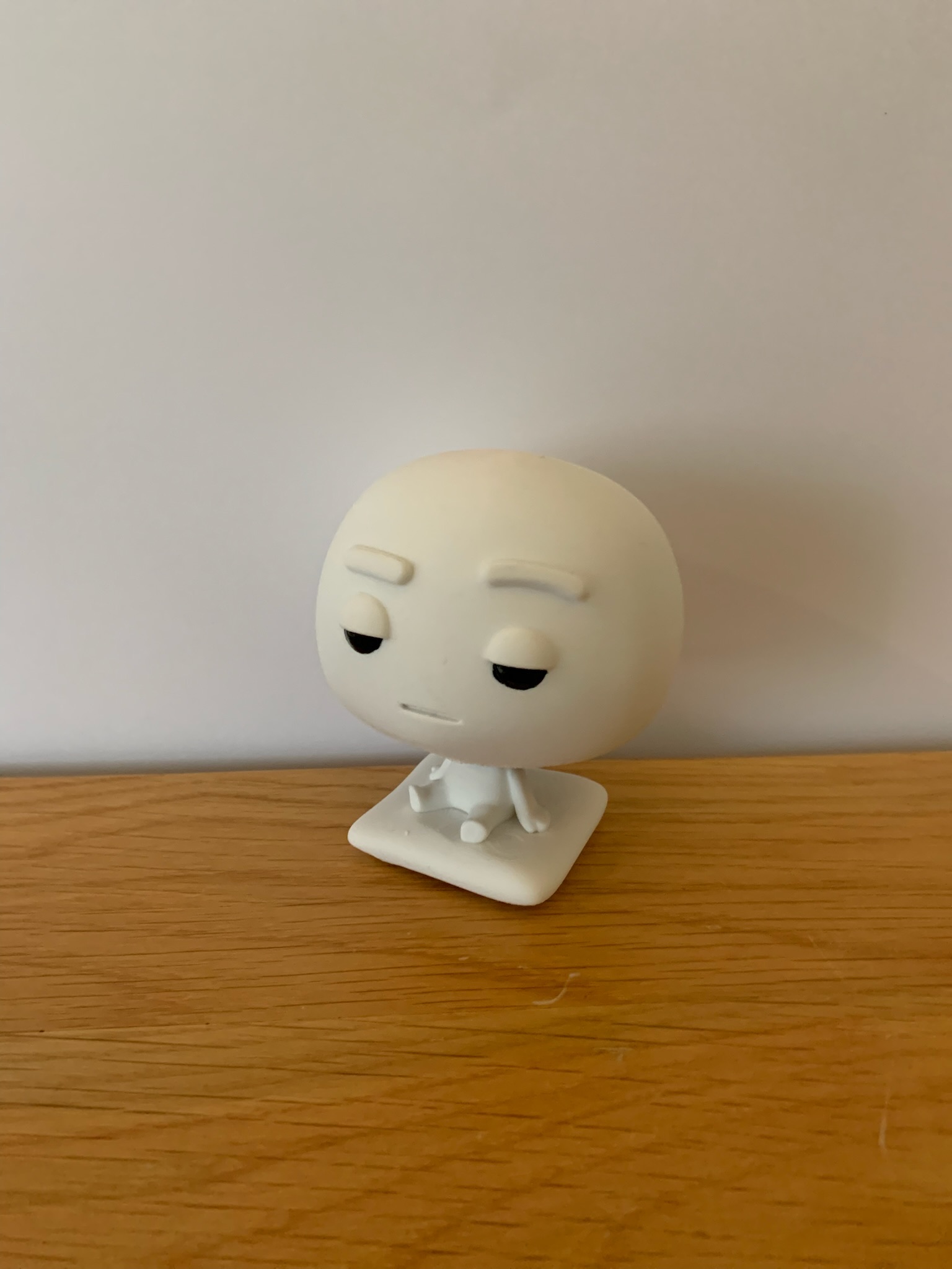 Pixl Nub device sitting alone on a wooden desk, clean white background